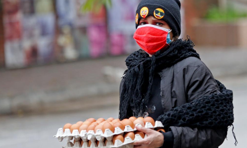 A woman goes out to buy eggs during the lockdown in Beirut, Lebanon, April 3, 2021. Lebanon registered on Friday 2,963 new COVID-19 cases, raising the total number of infections to 474,925, the Health Ministry reported. Lebanon began a 3-day total lockdown on Saturday for the Easter holiday to prevent a potential increase in COVID-19 infections. (Xinhua)