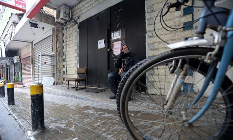 A man sits in front of a closed shop due to the lockdown in Beirut, Lebanon, April 3, 2021. Lebanon registered on Friday 2,963 new COVID-19 cases, raising the total number of infections to 474,925, the Health Ministry reported. Lebanon began a 3-day total lockdown on Saturday for the Easter holiday to prevent a potential increase in COVID-19 infections. (Xinhua)