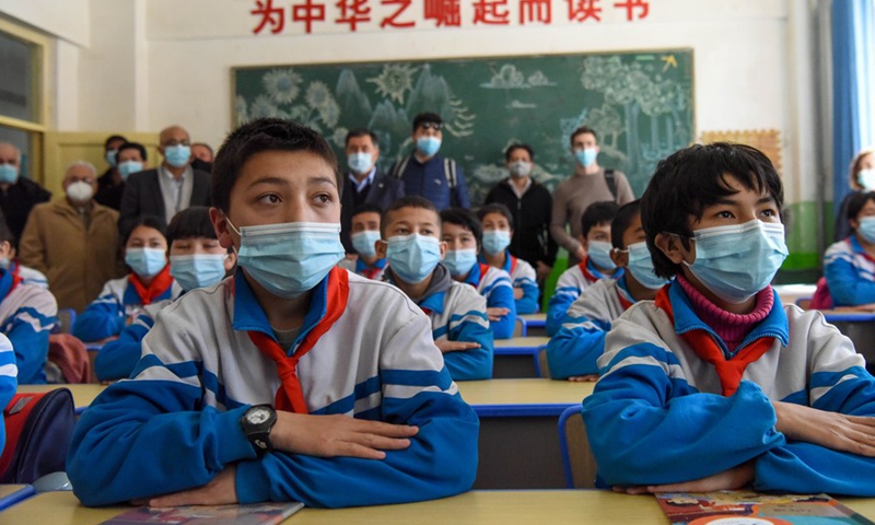 Foreign diplomats visit a primary school in Awat Township of Kashgar, northwest China's Xinjiang Uygur Autonomous Region, March 31, 2021. From March 30 to April 2, a delegation comprising Vladimir Norov, secretary-general of the Shanghai Cooperation Organization (SCO), and more than 30 diplomats from some 21 countries visited Xinjiang.Photo:Xinhua