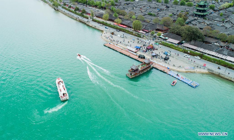 Aerial photo shows tourists viewing the Langzhong ancient city on boats in Nanchong, southwest China's Sichuan Province, April 3, 2021. (Photo by Wang Yugui/Xinhua)