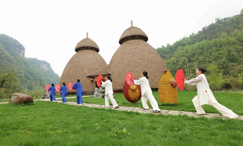People practice Taichi at Huanglongdong scenic area in Zhangjiajie, central China's Hunan Province, April 3, 2021.Photo:Xinhua