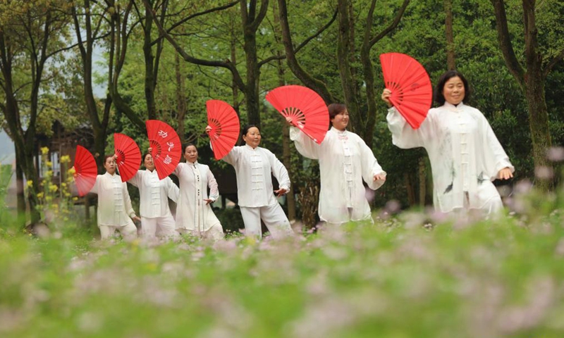 People practice Taichi at Huanglongdong scenic area in Zhangjiajie, central China's Hunan Province, April 3, 2021.Photo:Xinhua