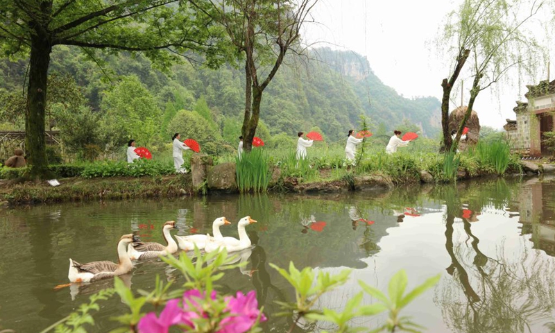 People practice Taichi at Huanglongdong scenic area in Zhangjiajie, central China's Hunan Province, April 3, 2021.Photo:Xinhua