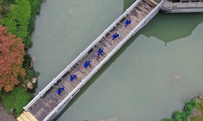 People practice Taichi at Huanglongdong scenic area in Zhangjiajie, central China's Hunan Province, April 3, 2021.Photo:Xinhua