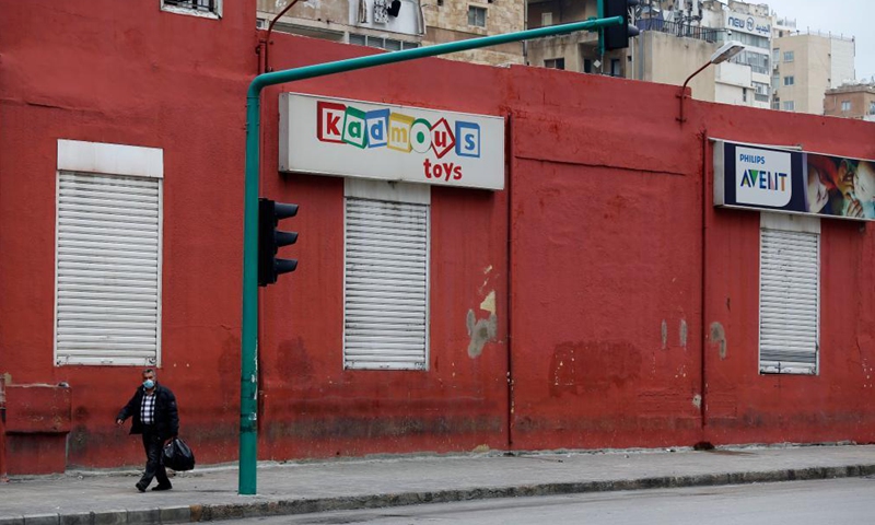 A man passes by closed shops due to the lockdown in Beirut, Lebanon, April 3, 2021. Lebanon registered on Friday 2,963 new COVID-19 cases, raising the total number of infections to 474,925, the Health Ministry reported. Lebanon began a 3-day total lockdown on Saturday for the Easter holiday to prevent a potential increase in COVID-19 infections. (Xinhua)