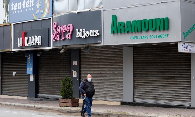A man passes by closed shops due to the lockdown in Beirut, Lebanon, April 3, 2021. Lebanon registered on Friday 2,963 new COVID-19 cases, raising the total number of infections to 474,925, the Health Ministry reported. Lebanon began a 3-day total lockdown on Saturday for the Easter holiday to prevent a potential increase in COVID-19 infections.  (Xinhua)