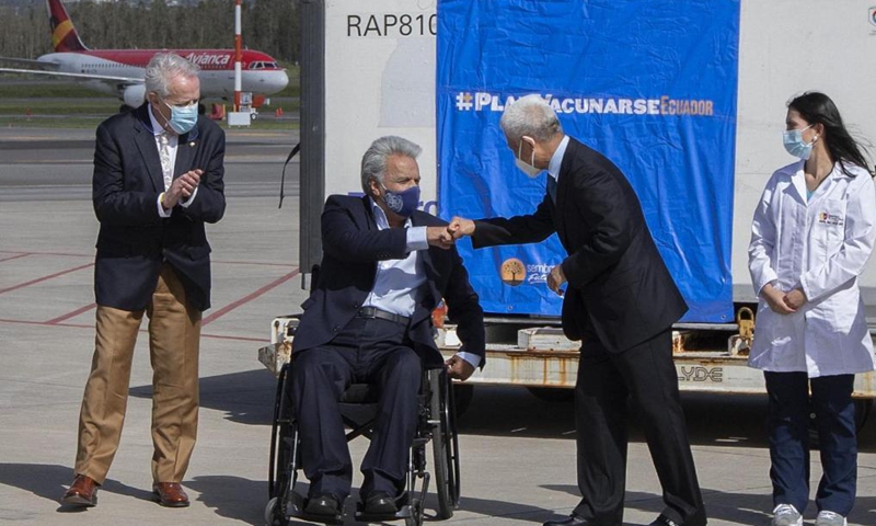 Ecuadorian President Lenin Moreno (2nd L) touches fists with Chinese Ambassador to Ecuador Chen Guoyou (2nd R) while attending a welcome ceremony for the arrival of the first batch of Chinese-developed Sinovac COVID-19 vaccines at an airport in Quito, Ecuador on April 7, 2021.Photo:Xinhua