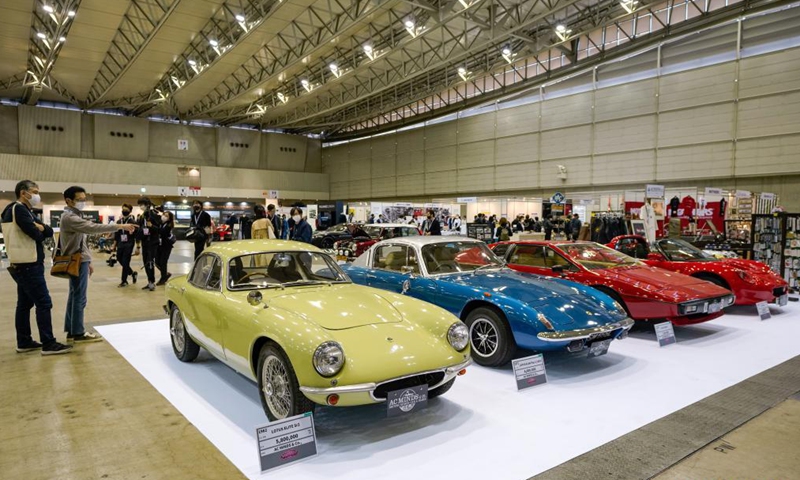 Visitors look at Lotus vehicles on display during the Automobile Council 2021 car show at Makuhari Messe convention center in Chiba, Japan on April 9, 2021. The show, displaying a wide range of classic vehicles, aims to promote automobile culture and lifestyle in Japan.Photo:Xinhua