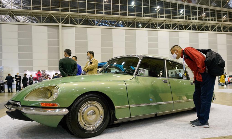 A visitor looks at a Citroen DS 23 on display during the Automobile Council 2021 car show at Makuhari Messe convention center in Chiba, Japan on April 9, 2021. The show, displaying a wide range of classic vehicles, aims to promote automobile culture and lifestyle in Japan.Photo:Xinhua