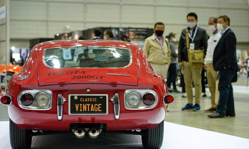 People look at a Toyota 2000GT on display during the Automobile Council 2021 car show at Makuhari Messe convention center in Chiba, Japan on April 9, 2021. The show, displaying a wide range of classic vehicles, aims to promote automobile culture and lifestyle in Japan.Photo:Xinhua