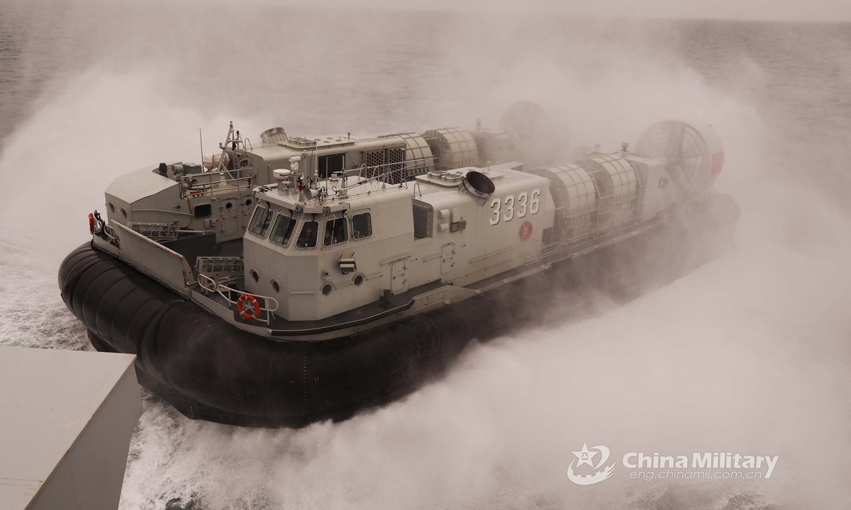 A Landing Craft, Air Cushion (LCAC) attached to a naval landing ship flotilla under the PLA Southern Theater Command approaches the well deck of the amphibious dock landing ship during a beach landing training exercise on March 24, 2021. The exercise involved such items as in and out of the mother-ship under complex sea conditions, fast and accurate ferry of troops, and simulated seizure and control of islands.Photo:China Military