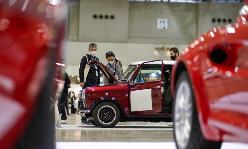 Visitors look at a David Brown Mini Remastered vehicle on display during the Automobile Council 2021 car show at Makuhari Messe convention center in Chiba, Japan on April 9, 2021. The show, displaying a wide range of classic vehicles, aims to promote automobile culture and lifestyle in Japan.Photo:Xinhua