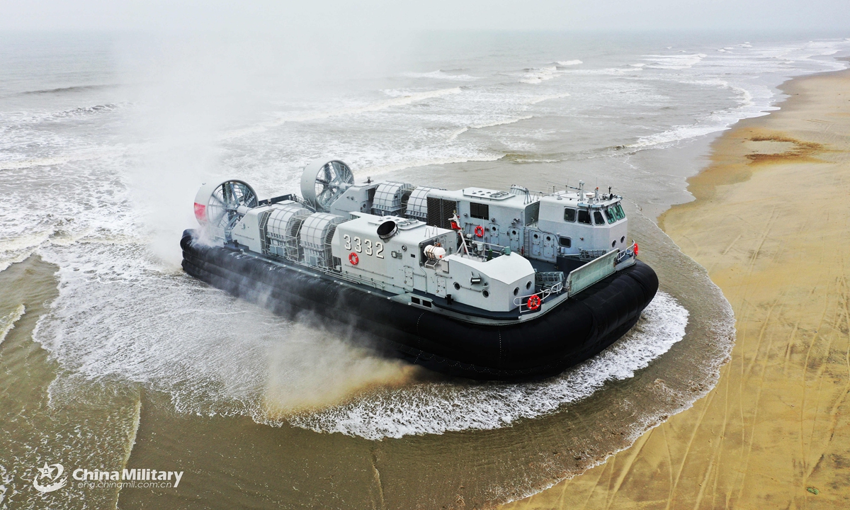 A Landing Craft, Air Cushion (LCAC) attached to a naval landing ship flotilla under the PLA Southern Theater Command arrives on shore during a beach landing training exercise on March 24, 2021. The exercise involved such items as in and out of the mother-ship under complex sea conditions, fast and accurate ferry of troops, and simulated seizure and control of islands.Photo:China Military