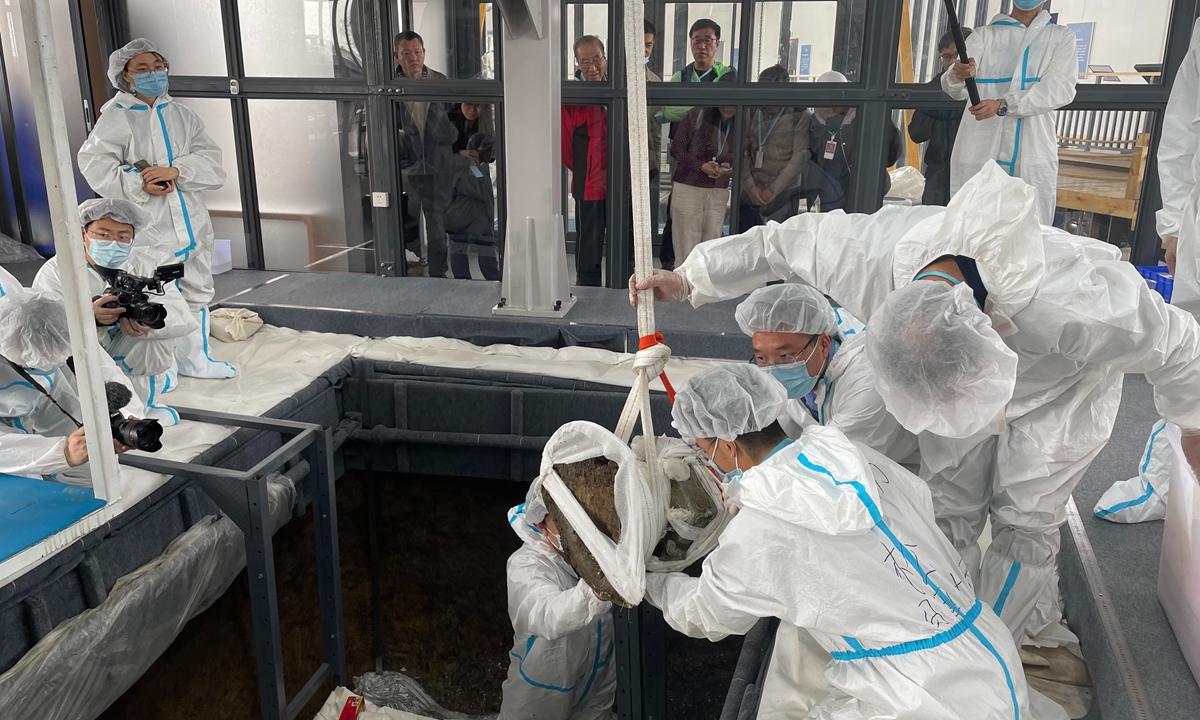 Chinese archaeologists excavate a bronze item with a rare round-shaped mouth on Monday Photo: Courtesy of Sanxingdui Ruins site