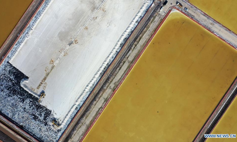 Aerial photo taken on April 13, 2021 shows large machines working in a salt pond in the Changlu Hangu salt field in north China's Tianjin Municipality. The spring harvest season started in the salt field recently and is expected to last till mid-May. (Photo: Xinhua)