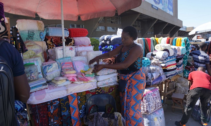 Rebecca Phiri, a trader dealing in baby wear and beddings, works at a market in Lusaka, Zambia, on April 5, 2021.(Photo: Xinhua)