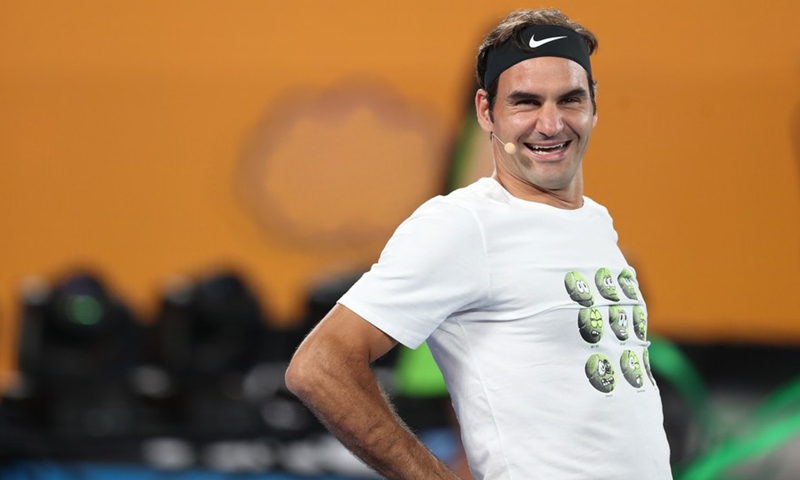 Roger Federer of Switzerland laughs during an exhibition match on Kids Tennis Day, held at Melbourne Park in Melbourne, Australia, Jan. 13, 2018.(Photo: Xinhua)