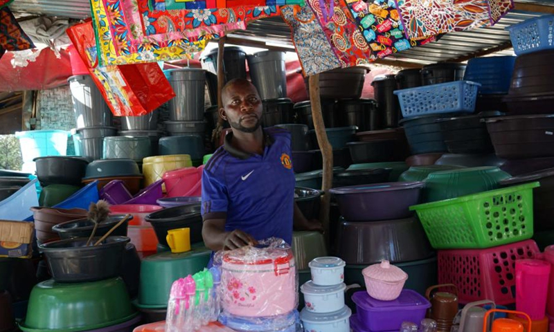 Boyd Siame, a household products dealer, works at a market in Mandevu Township, Lusaka, Zambia, on March 17, 2021.(Photo: Xinhua)