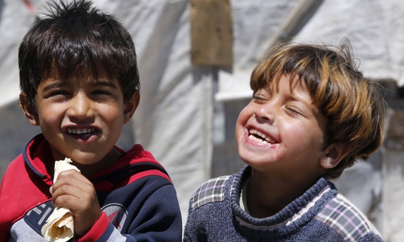 Children laugh at a Syrian refugee camp in Bar Elias, Bekaa Valley, eastern Lebanon, on June 19, 2018, ahead of World Refugee Day.(Photo: Xinhua)