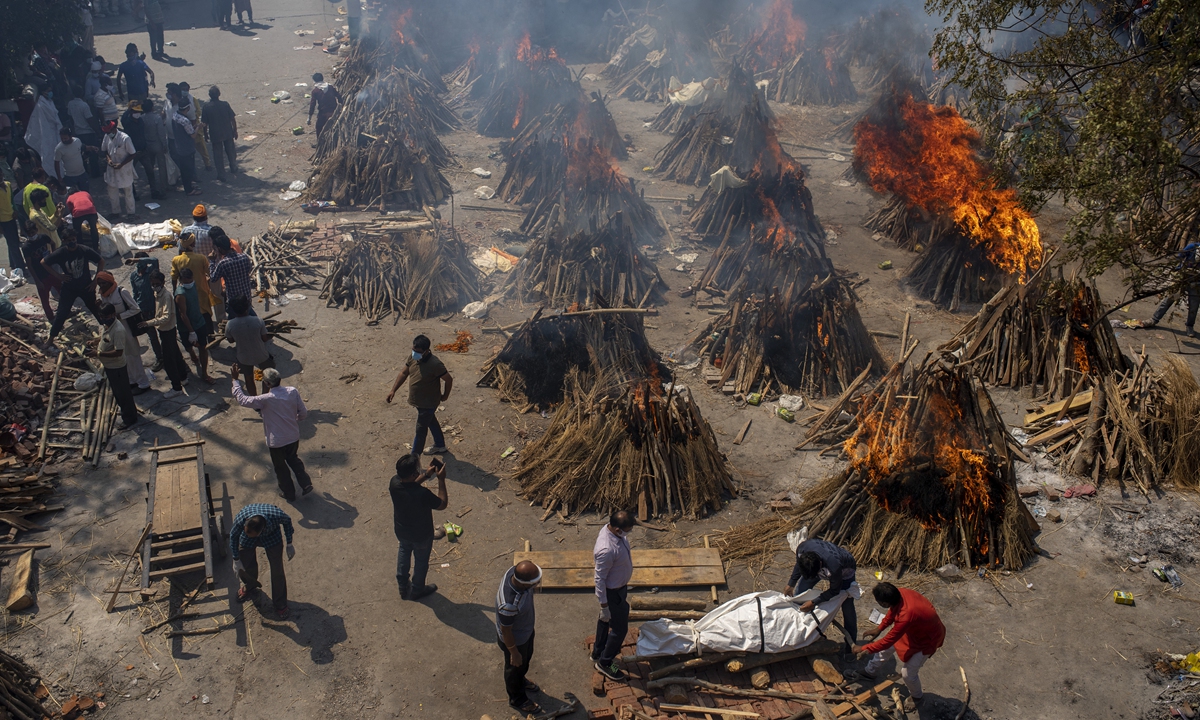 Multiple funeral pyres of COVID-19 victims burn at a site converted for mass cremations in New Delhi, India on Saturday.  Indian authorities are scrambling to get medical oxygen to hospitals when the country reported a new global daily record of more than 346,000 infections for a third straight day. Photo: AP 