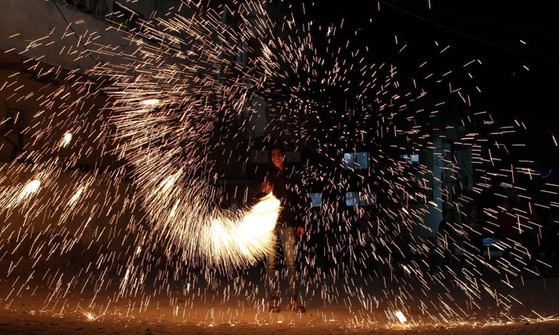 A Palestinian man plays with fireworks during the Islamic holy month of Ramadan in Gaza city, on April 16, 2021.Photo:Xinhua