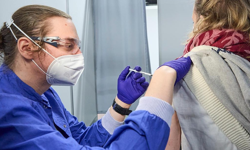 A woman receives a dose of COVID-19 vaccine inside Austria's largest vaccination site at the Austria Center in Vienna, Austria, on April 16, 2021.Photo:Xinhua