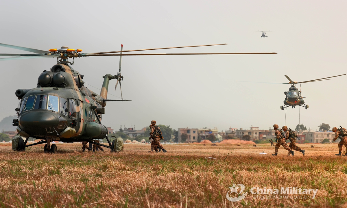 Soldiers assigned to a combined arms brigade under the PLA 73rd Group Army queue to board a transport helicopter during day-and-night fast-roping training in early April, 2021.Photo:China Military