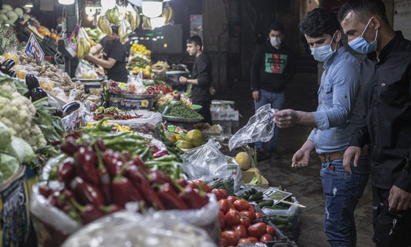 People shop to prepare for the Muslim holy month of Ramadan at a bazaar in Tehran, Iran, on April 13, 2021.(Photo: Xinhua)