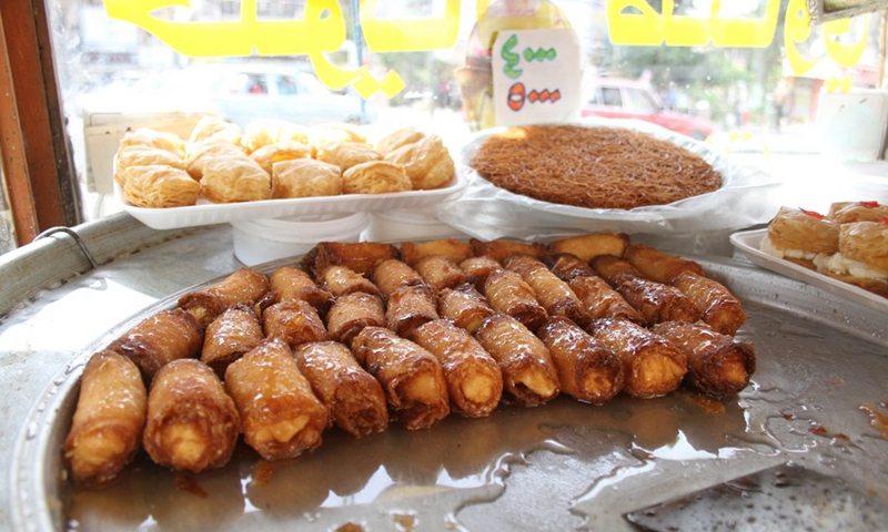 Traditional sweets are seen in a cart in a popular market in Tripoli, the second largest city of Lebanon, on April 19, 2021. (Photo: Xinhua)
