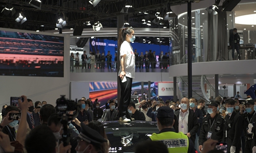 A protester standing on a Tesla Model 3 on 2021 Shanghai Auto Show.  Photo: CFP