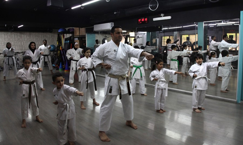 Members of Palestinian Bsharat family practice karate at a local gymnasium in the West Bank city of Nablus, on April 4, 2021.(Photo: Xinhua)