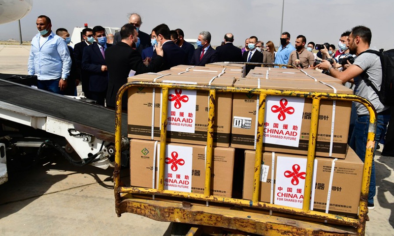 Boxes of Chinese COVID-19 vaccines are unloaded from a plane at the international airport in Damascus, Syria, on April 24, 2021.(Photo: Xinhua)