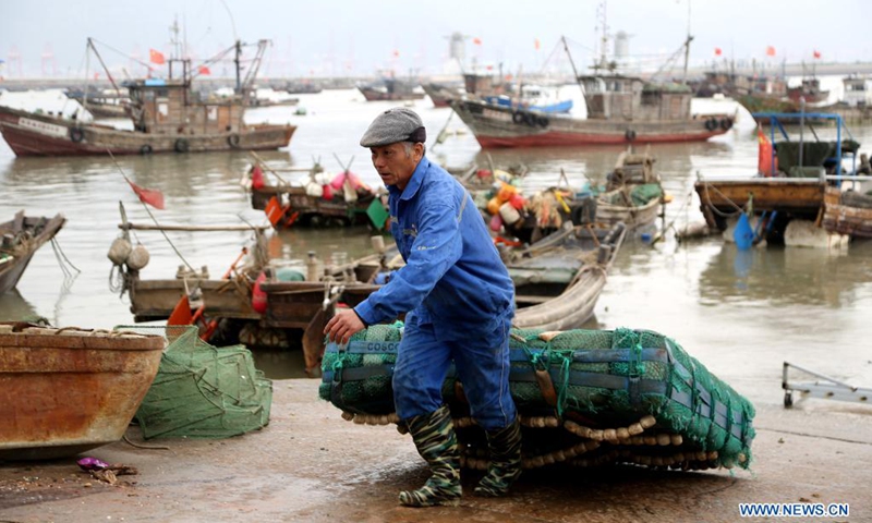 A fisherman transfers his fishing gear from boat before the enforcement of annual summer fishing ban, at a port in Lianyungang, east China's Jiangsu Province, April 30, 2021. The annual summer fishing ban, covering the Bohai Sea, the Yellow Sea, the East China Sea, and the waters north to 12 degrees north latitude of the South China Sea, started Saturday. Photo:Xinhua