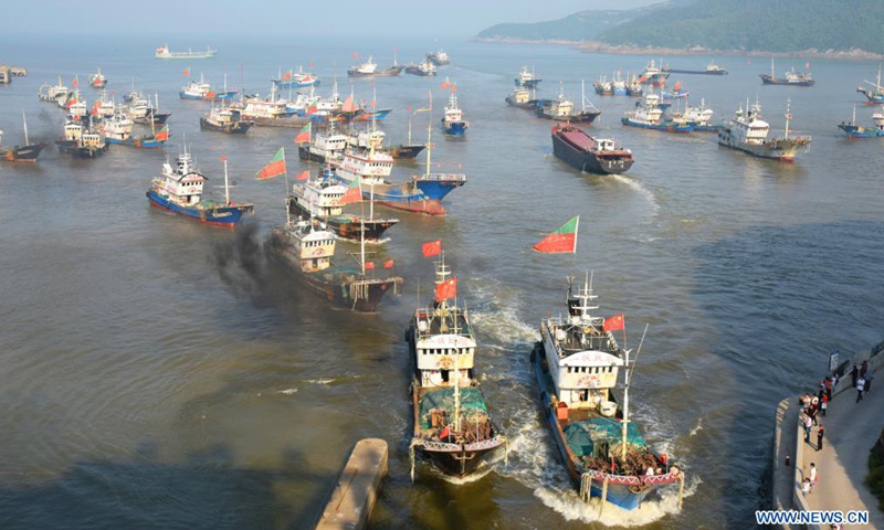 Photo taken on April 30, 2021 shows fishing vessels sail back to a port before the enforcement of annual summer fishing ban, at Jinqing Town of Luqiao District in Taizhou, east China's Zhejiang Province. The annual summer fishing ban, covering the Bohai Sea, the Yellow Sea, the East China Sea, and the waters north to 12 degrees north latitude of the South China Sea, started Saturday.Photo:Xinhua