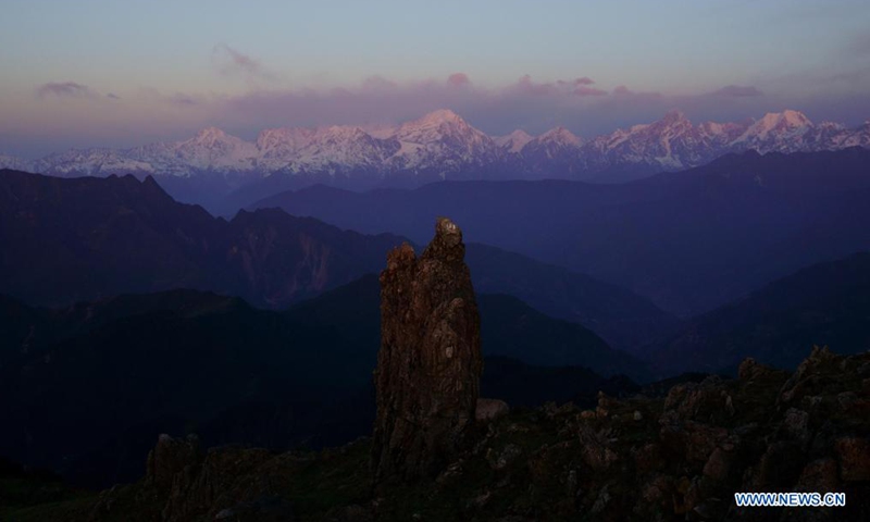 Gongga Mountain is seen from the top of the Niubei Mountain at dawn in southwest China's Sichuan Province, May 2, 2021. The Niubei Mountain, with an altitude of 3,600 meters, spans from Yingjing County to Luding County in southwest China's Sichuan. There is a scenic area on its top under construction, with a sightseeing platform, a parking lot, a wooden house hotel and a tent hotel. (Xinhua/Jiang Hongjing)