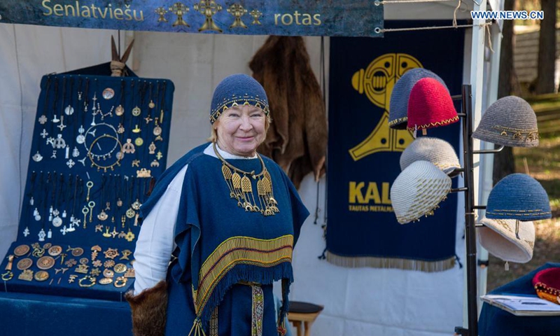 A vendor sells traditional Latvian jewelery at a spring market in Riga, Latvia, on May 1, 2021.  Photo: Xinhua