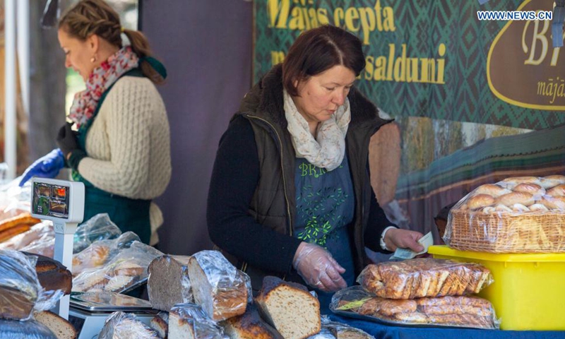 A vendor sells bread at a spring market in Riga, Latvia, on May 1, 2021.  Photo: Xinhua