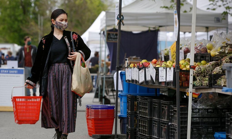 A woman visits a summer Vancouver farmers market in Vancouver, British Columbia, Canada, on May 1, 2021. The 2021 summer Vancouver Farmers Markets kicked off on Saturday and will run till October in several locations across the city.  Photo: Xinhua