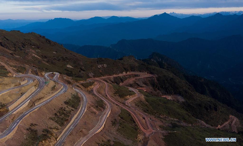Aerial photo taken on May 1, 2021 shows a nearly complete road to the top of the Niubei Mountain in southwest China's Sichuan Province. The Niubei Mountain, with an altitude of 3,600 meters, spans from Yingjing County to Luding County in southwest China's Sichuan. There is a scenic area on its top under construction, with a sightseeing platform, a parking lot, a wooden house hotel and a tent hotel. (Xinhua/Jiang Hongjing)