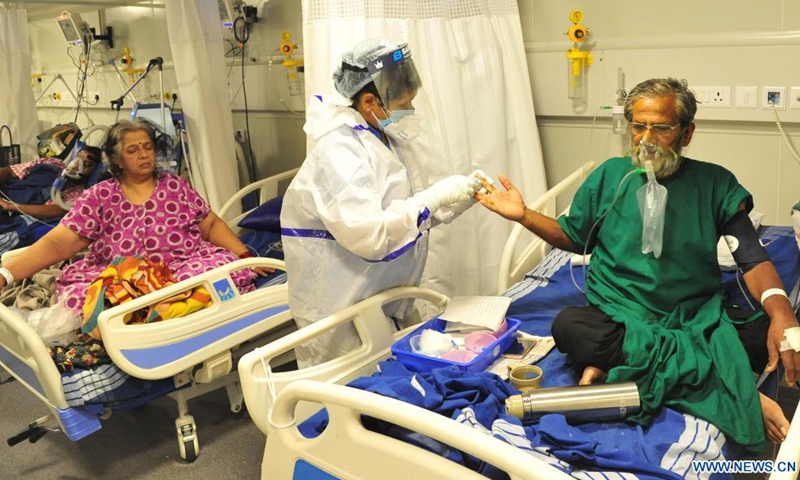 Patients receive treatment inside a COVID-19 ward in a hospital, in Bangalore, India, April 30, 2021. India's COVID-19 tally reached 19,164,969 on Saturday, with a single day spike of 401,993 cases, the health ministry said. This is the first time when over 400,000 new cases were recorded in India in 24 hours, and a record number of 3,523 deaths since Friday morning took the total death toll to 211,853. (Str/Xinhua)