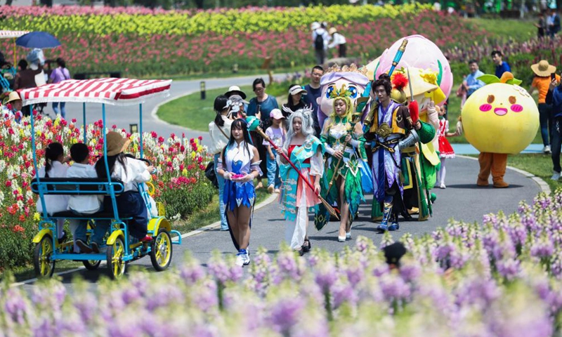 Cartoon characters and cosplayers parade in the flower fields in Jingshan Township of Yuhang District in Hangzhou, capital of east China's Zhejiang Province, May 2, 2021. From May 1 to May 5, an animation carnival is held at the flower fields at the Jingshan Town of Yuhang District of Hangzhou. (Xinhua/Xu Yu)