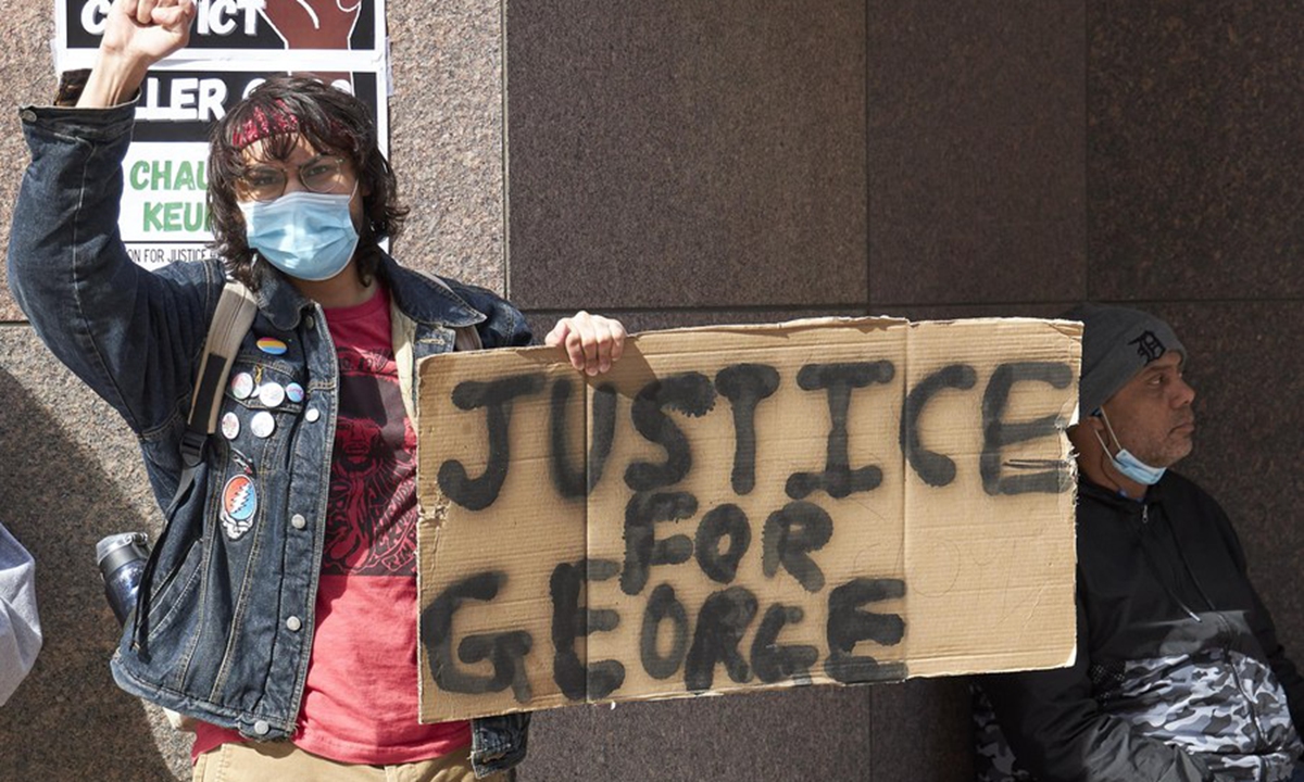 Protestors are seen outside the Hennepin County courthouse in Minneapolis, Minnesota, the United States, March 9, 2021. (Photo by Matthew Mcintosh/Xinhua)