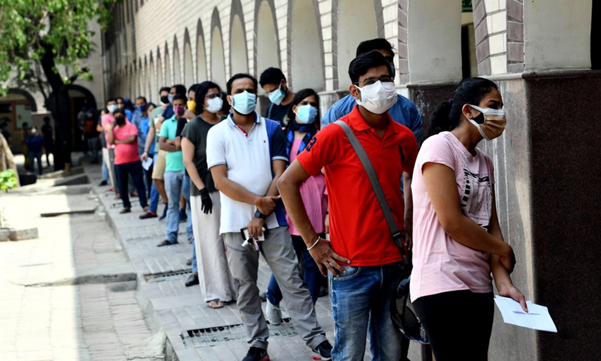 People wait to receive COVID-19 vaccination at a government school in Delhi, India, on May 3, 2021. (Xinhua/Partha Sarkar)