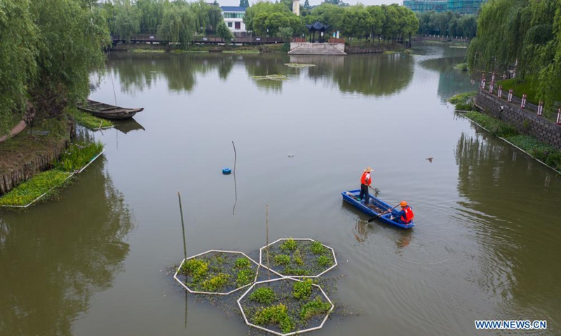 Aerial photo taken on May 8, 2021 shows sanitation workers patrolling and cleaning a watercourse in Donglin Township of Huzhou City, east China's Zhejiang Province. Donglin Township has engaged all local residents in protecting the ecological environment by reducing pollutants such as floating dusts from the source.Photo:Xinhua
