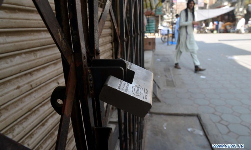 A closed shop is seen at a market in northwest Pakistan's Peshawar on May 8, 2021. In its efforts to curb the third wave of COVID-19, the Pakistani government has ramped up restriction across the country for the upcoming holidays of Eid al-Fitr festival, urging the public to stay at home to keep themselves and their loved ones safe.(Photo: Xinhua)