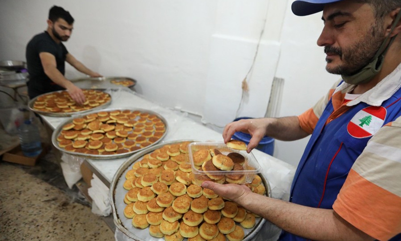 Workers pack Ma'amoul, a special sweet for Eid al-Fitr, at a sweet shop in Beirut, Lebanon, on May 9, 2021.(Photo: Xinhua)