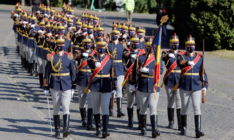 Romanian soldiers of an honor guard attend a ceremony marking the 76th anniversary of the end of World War II in Europe, known as Victory in Europe Day, at an event organized in front of Military Academy in Bucharest, Romania, May 9, 2021. (Photo: Xinhua)