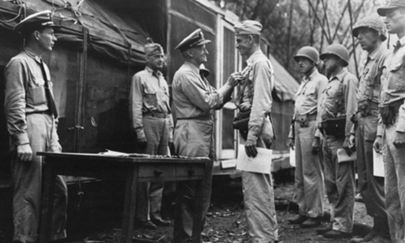 Carlson is decorated with the Navy Cross by Five-Star Admiral Chester William Nimitz for his victory on Makin Island