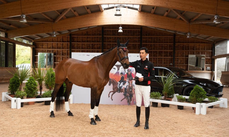 Alex Hua Tian rides his horse Don during a press conference in Cheshire, Britain, on May 14, 2021. China's first Olympic rider Alex Hua Tian unveiled his new 'Hoof Print to Tokyo' slogan for the Olympic Games at the press conference at Pinfold Stables in Cheshire, Britain.Photo:Xinhua