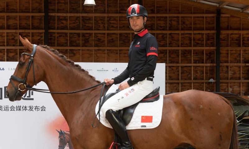 Alex Hua Tian rides his horse Don during a press conference in Cheshire, Britain, on May 14, 2021. China's first Olympic rider Alex Hua Tian unveiled his new 'Hoof Print to Tokyo' slogan for the Olympic Games at the press conference at Pinfold Stables in Cheshire, Britain.Photo:Xinhua